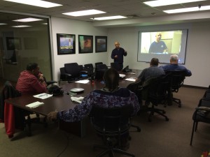 A group of people in a conference room gather for a jobs training program
