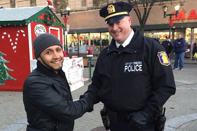 Hector the Connector turns to the camera along with a police officer to demonstrate the Stop & Shake movement